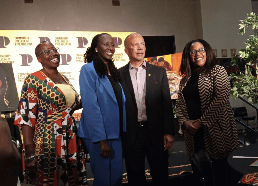 Aminata Sy stands with Dr. Donald Generals Aminata Sy stands with Dr. Donald Generals, president of Community College of Philadelphia (CCP), and faculty members who led the program.